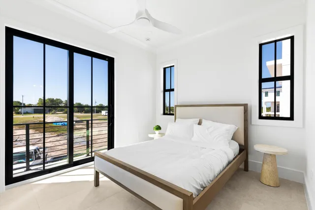a bedroom with a large bed and a large window