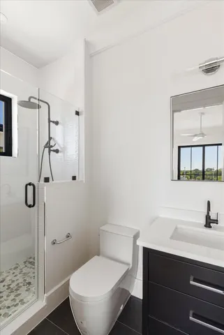 a bed sitting in a spacious bedroom next to a window