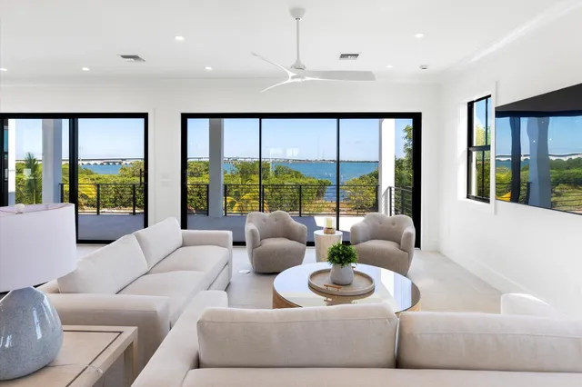 a living room with furniture and large windows