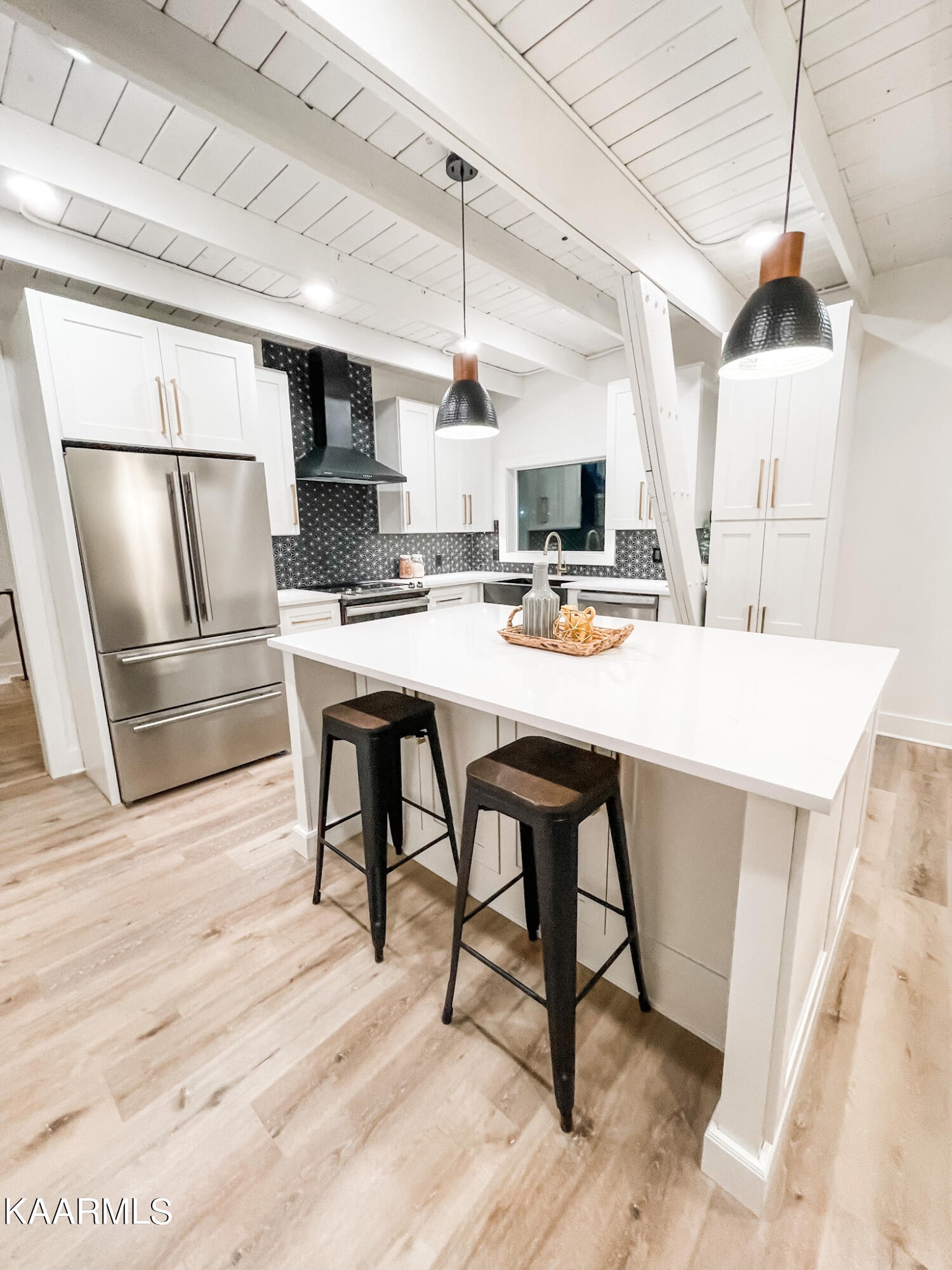 232 East Red Bud Road Knoxville, TN 37920 - Photo 10 of 34 a kitchen with stainless steel appliances a stove a refrigerator and white cabinets with wooden floor
