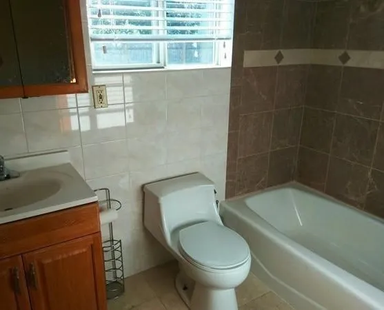a bathroom with a toilet a sink and bathtub
