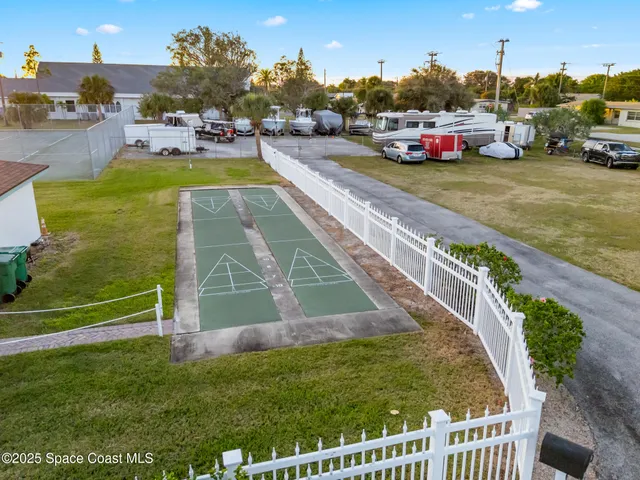 a view of a swimming pool with a yard and sitting area