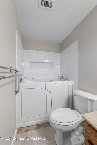 a white toilet sitting next to a bathroom sink