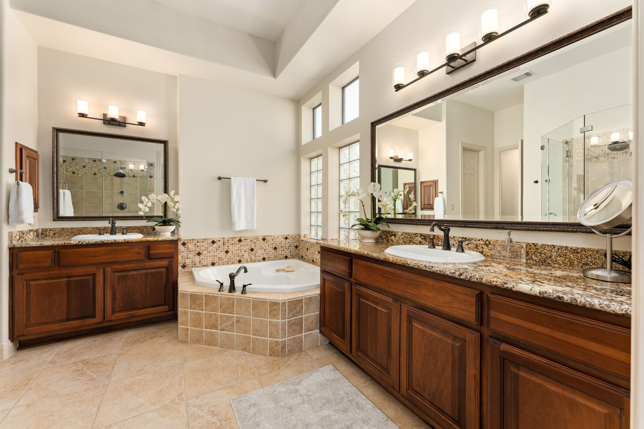 205 Emerald Ridge Drive Austin, TX 78732 - Photo 17 of 40 a bathroom with a granite countertop double vanity sink large mirror and bathtub