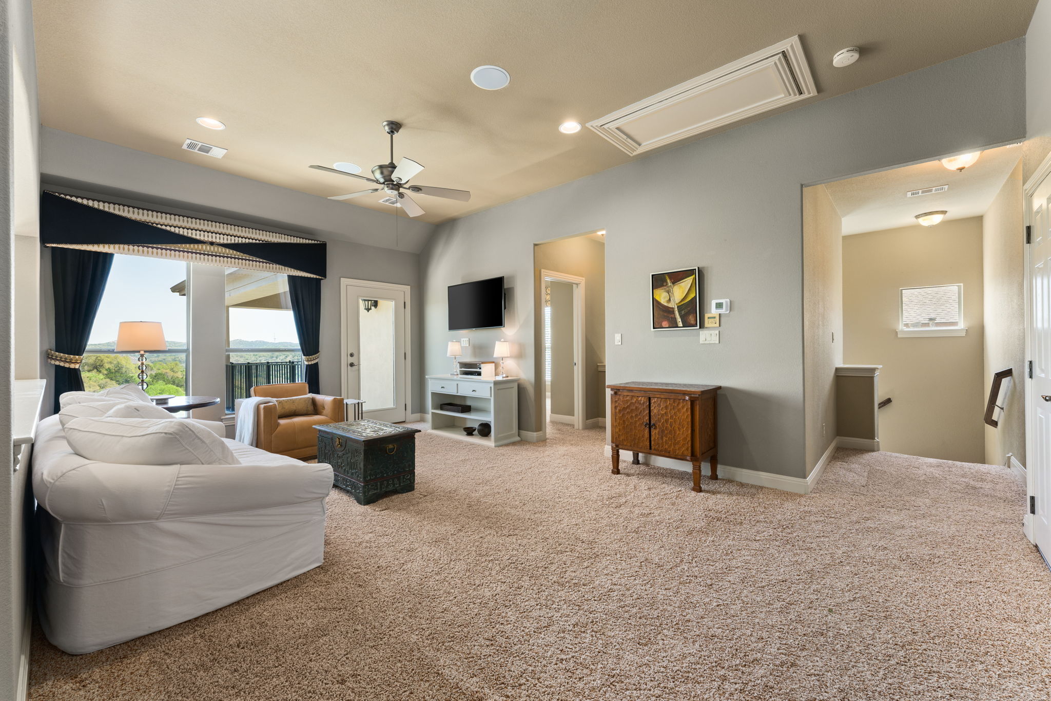 205 Emerald Ridge Drive Austin, TX 78732 - Photo 19 of 40 a living room with furniture and a chandelier