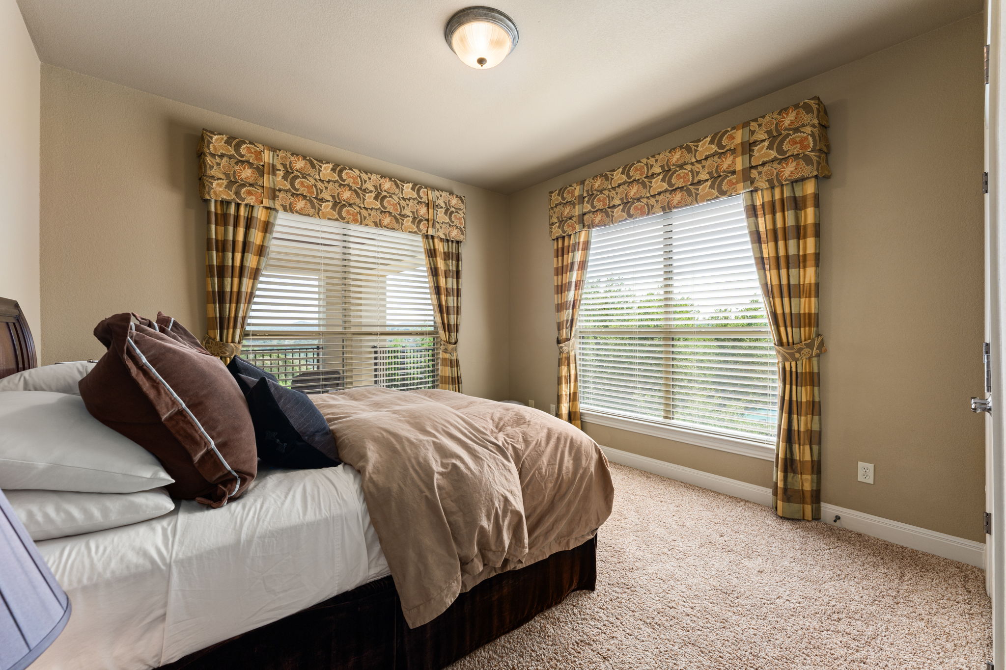 205 Emerald Ridge Drive Austin, TX 78732 - Photo 22 of 40 a bedroom with a bed and a window