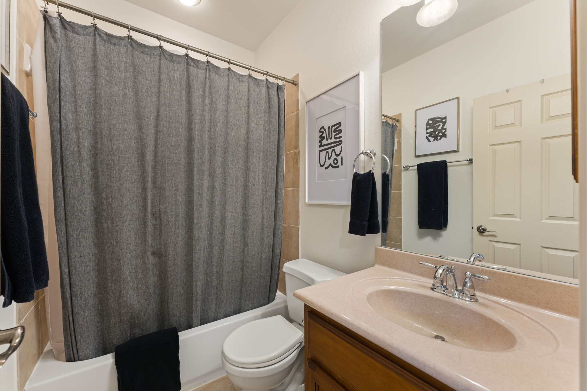 205 Emerald Ridge Drive Austin, TX 78732 - Photo 25 of 40 a bathroom with a sink a toilet and shower curtain