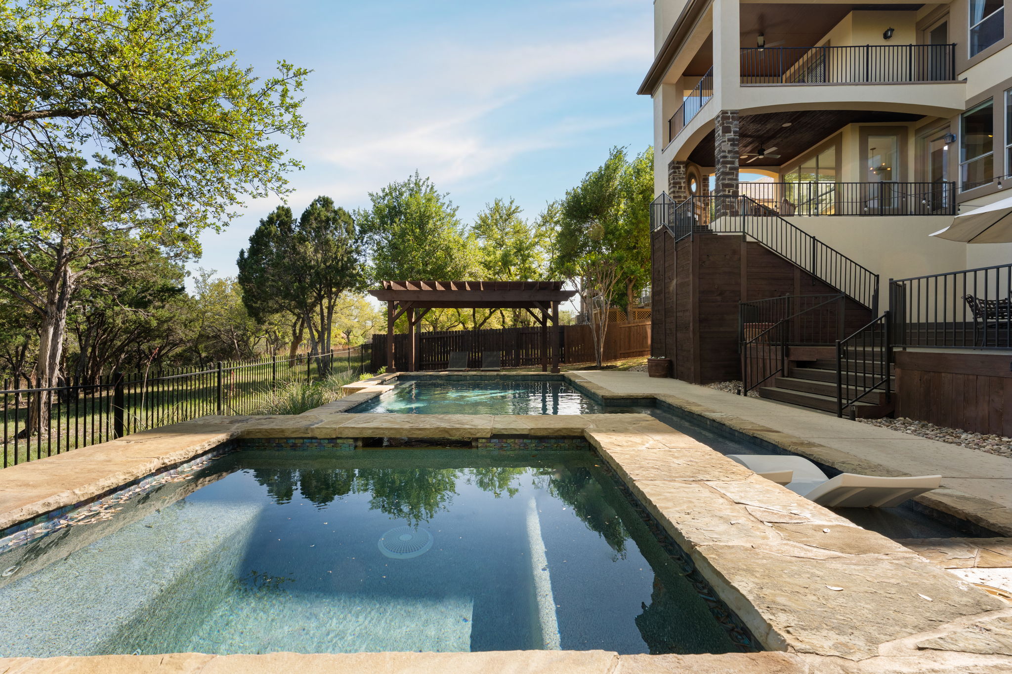 205 Emerald Ridge Drive Austin, TX 78732 - Photo 34 of 40 a view of swimming pool with a bench