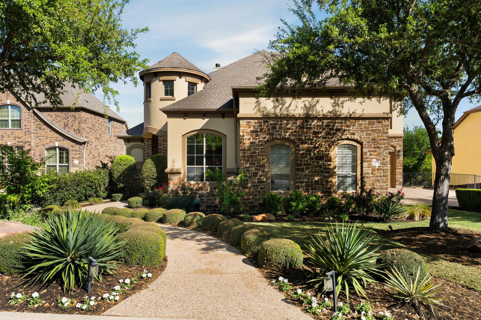 205 Emerald Ridge Drive Austin, TX 78732 - Photo 40 of 40 a front view of a house with a garden
