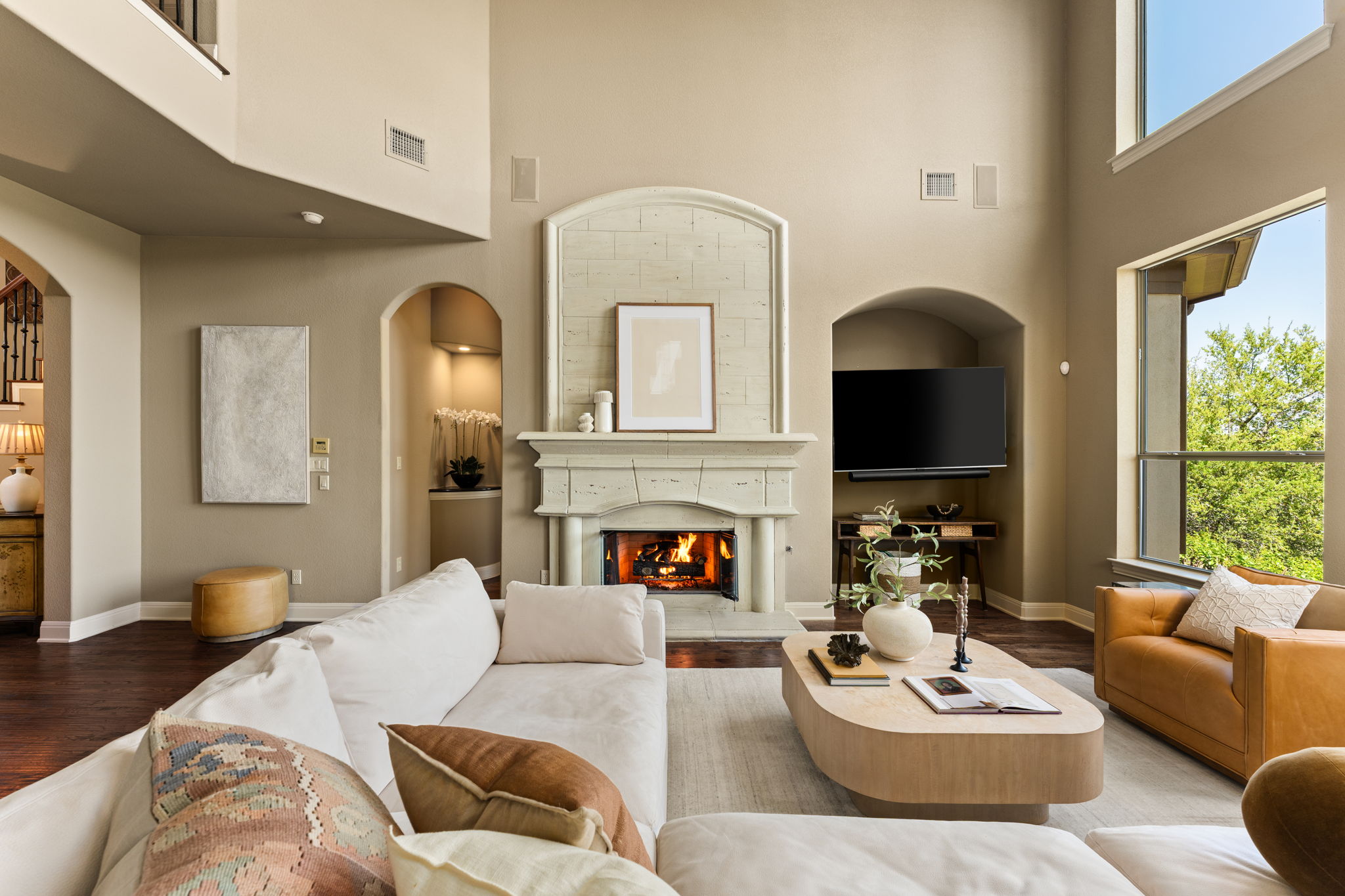 205 Emerald Ridge Drive Austin, TX 78732 - Photo 5 of 40 a living room with furniture a fireplace and a large window