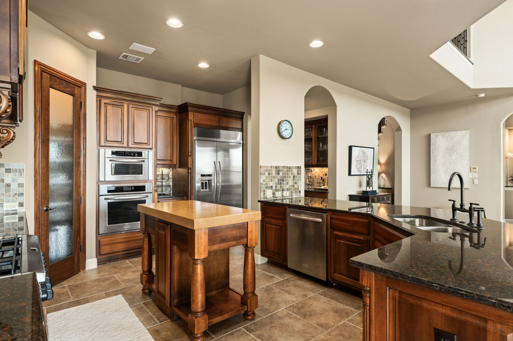 205 Emerald Ridge Drive Austin, TX 78732 - Photo 9 of 40 a kitchen with stainless steel appliances granite countertop a sink a stove and a refrigerator