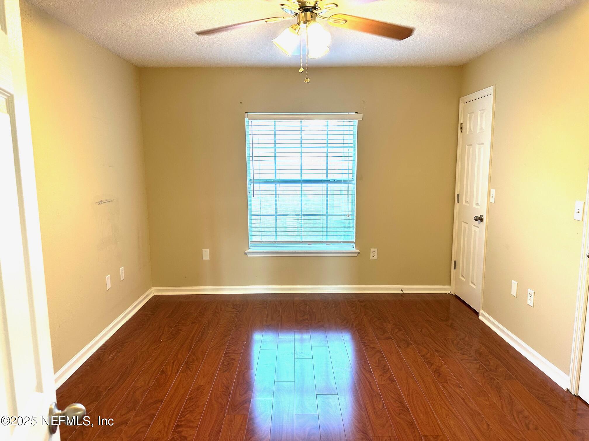 1523 Fieldview Drive Jacksonville, FL 32225 - Photo 12 of 23 an empty room with wooden floor and fan