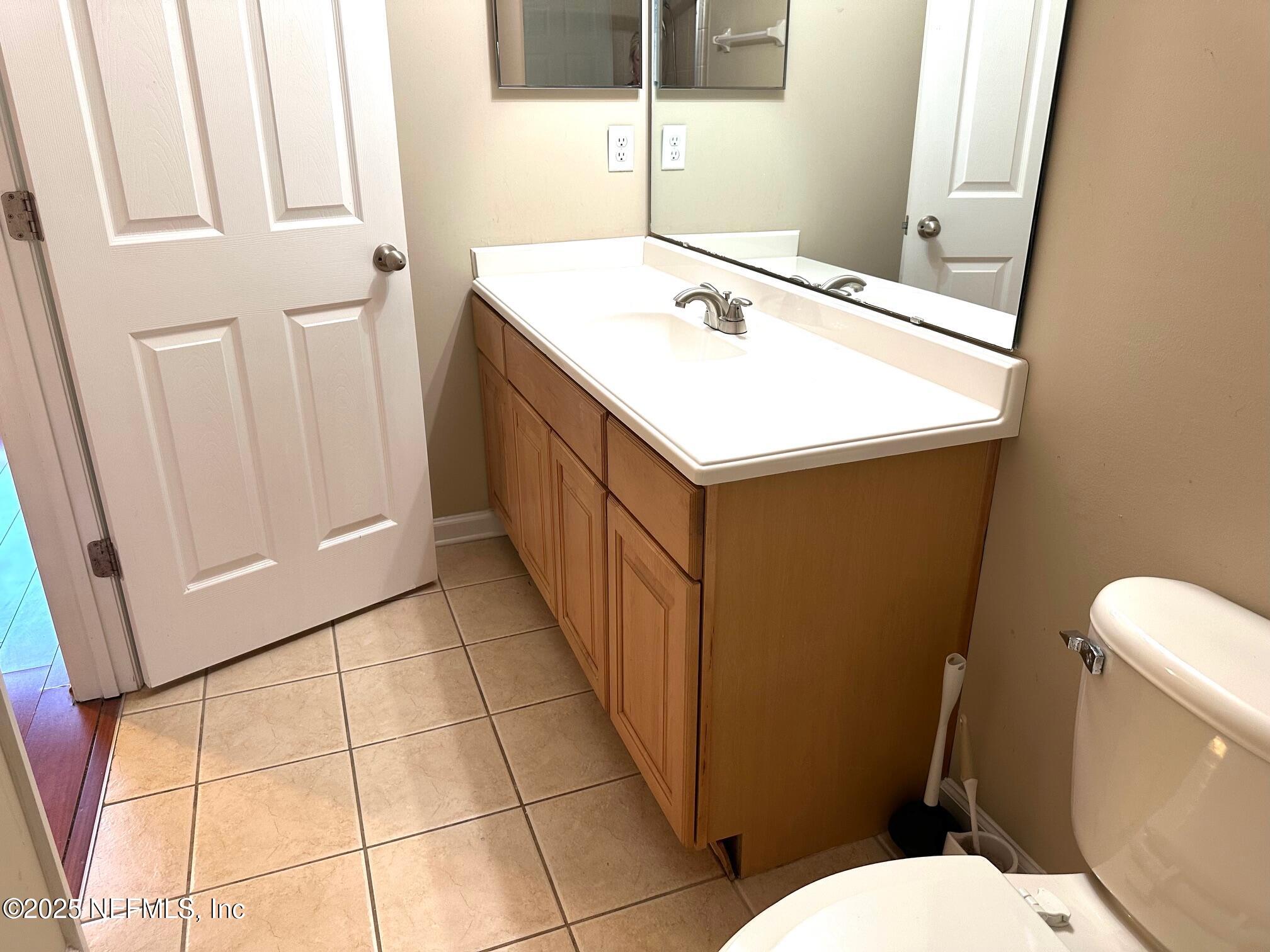 1523 Fieldview Drive Jacksonville, FL 32225 - Photo 15 of 23 a bathroom with a sink a toilet and a mirror