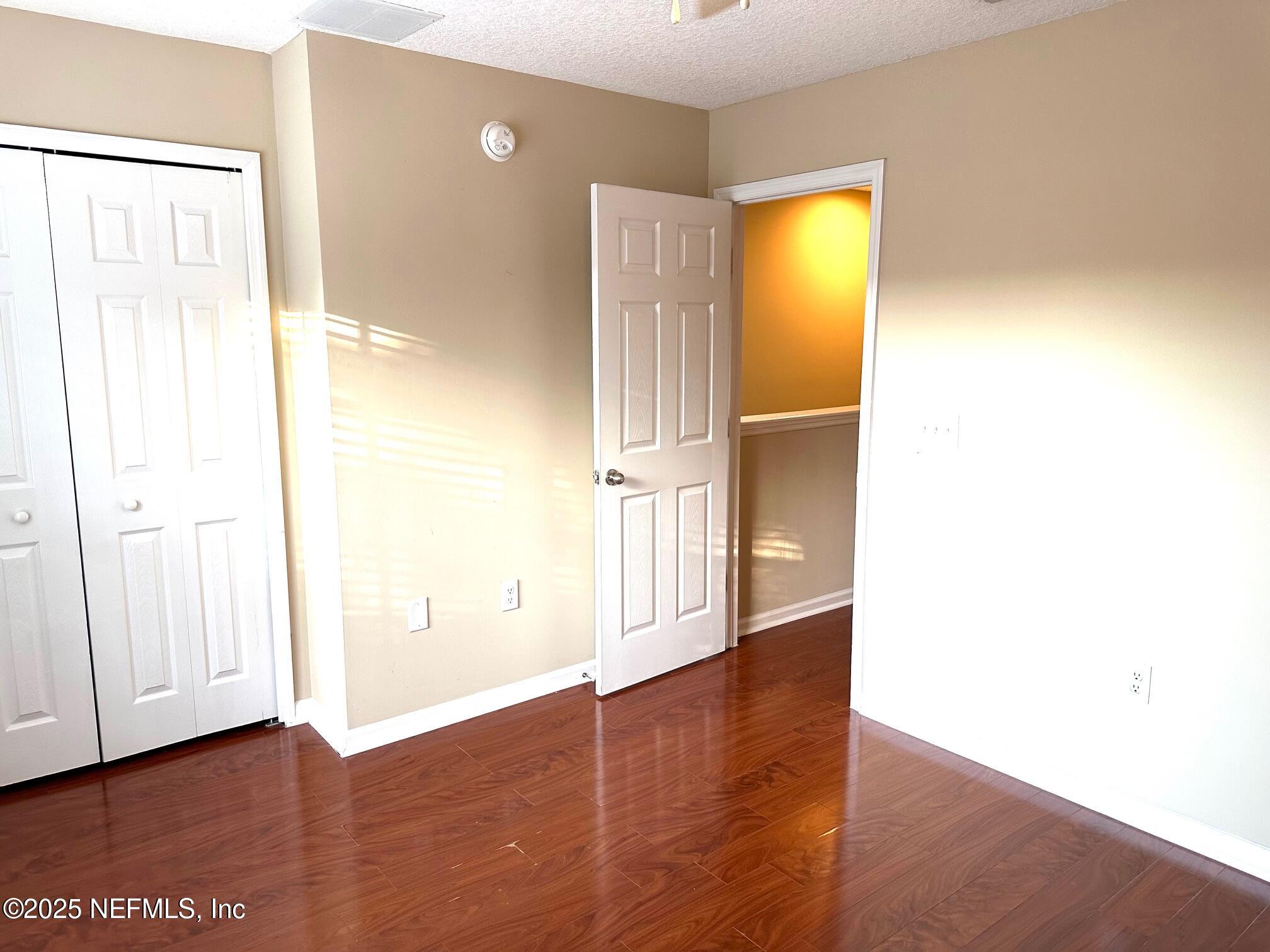 1523 Fieldview Drive Jacksonville, FL 32225 - Photo 16 of 23 a view of an empty room with wooden floor and a window