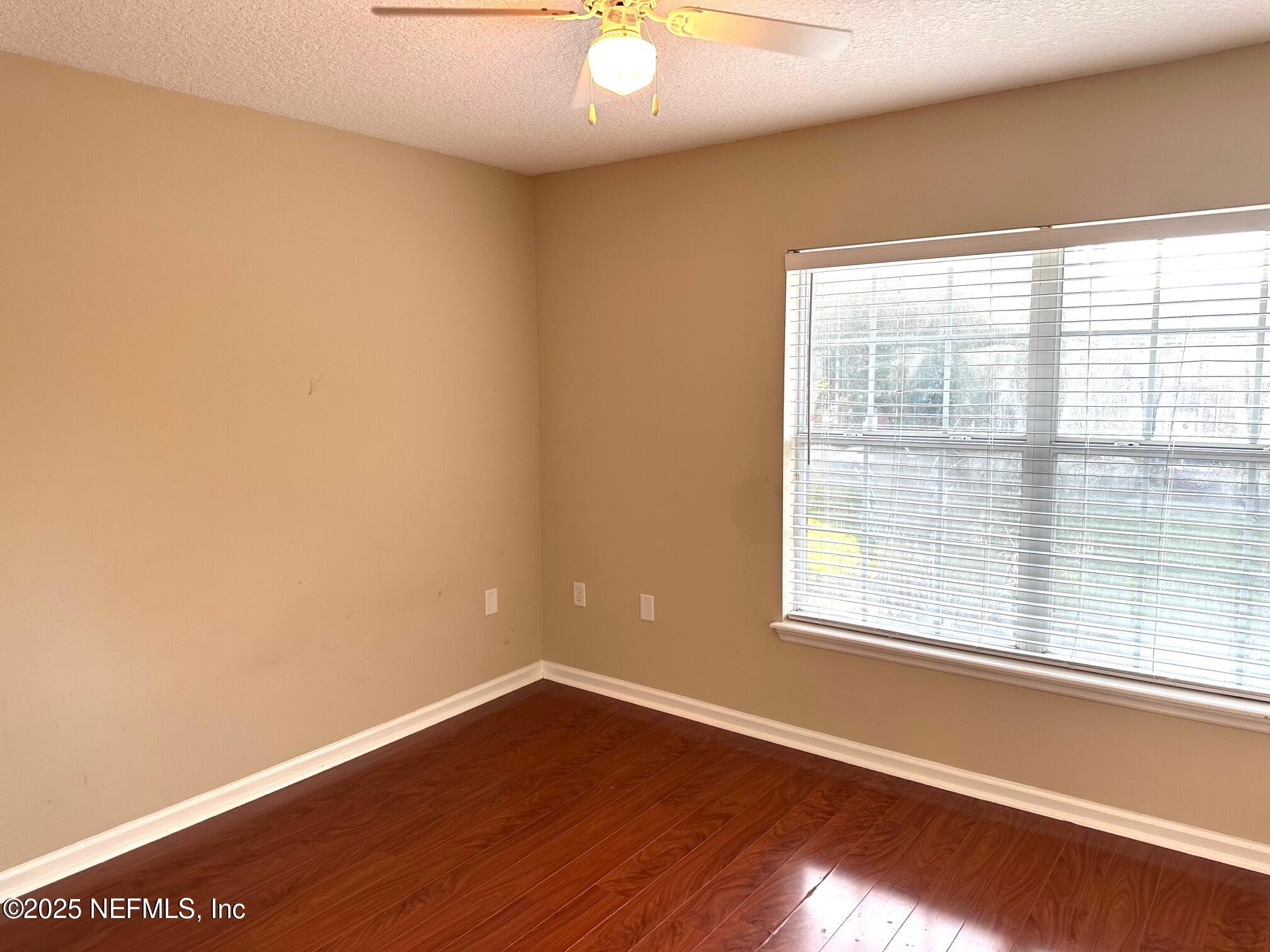 1523 Fieldview Drive Jacksonville, FL 32225 - Photo 17 of 23 an empty room with wooden floor and windows