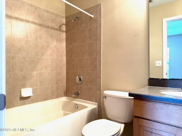 a bath room with a toilet and a bath tub