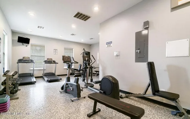 a room with gym equipment and a large window