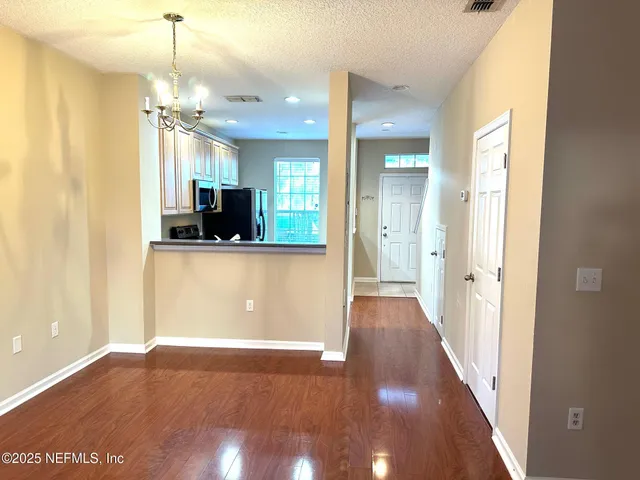 a view of a kitchen cabinets and wooden floor