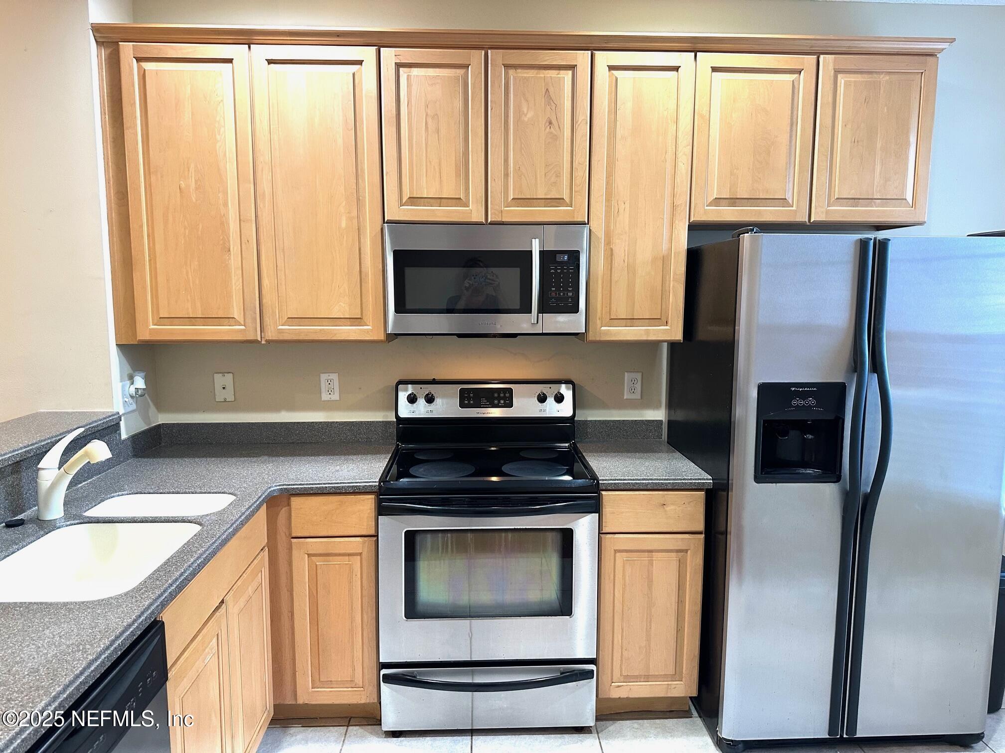 1523 Fieldview Drive Jacksonville, FL 32225 - Photo 7 of 23 a kitchen with granite countertop a stove sink and microwave