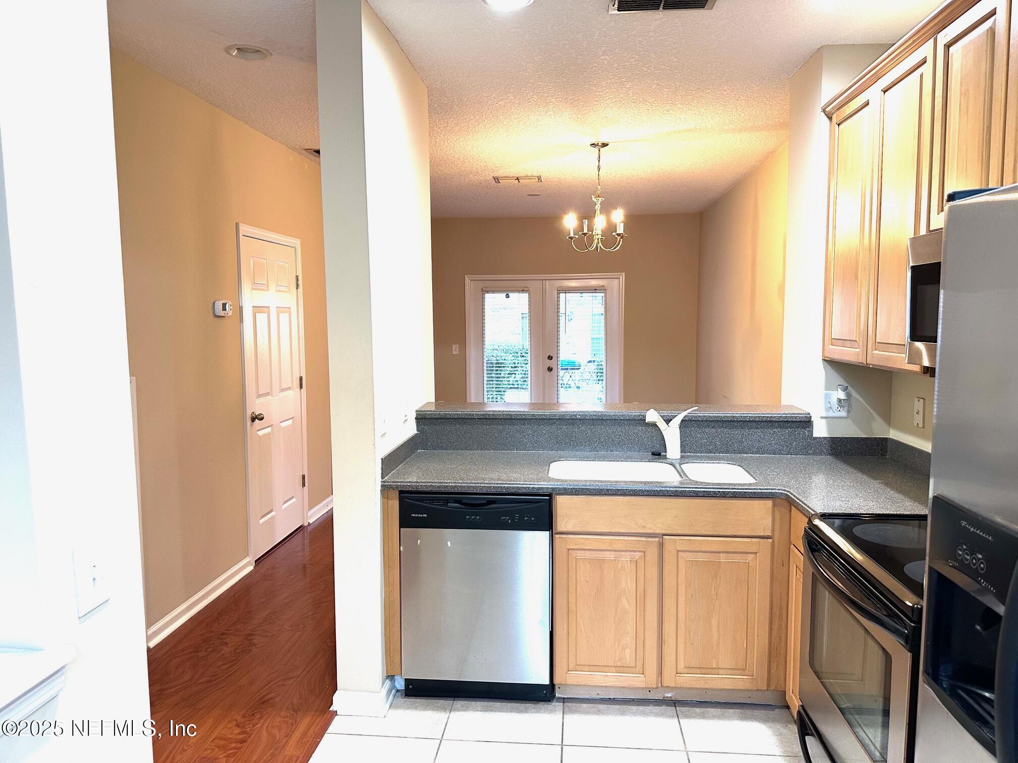 1523 Fieldview Drive Jacksonville, FL 32225 - Photo 8 of 23 a kitchen with kitchen island a sink stove and refrigerator