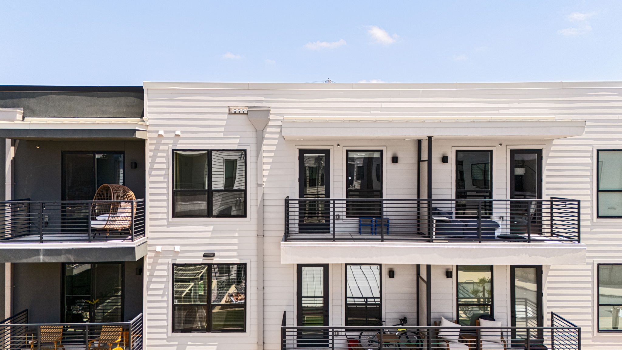 1701 Simond Avenue, Unit 612 Austin, TX 78723 - Photo 24 of 40 Modern multi-story building featuring white horizontal siding and dark framed windows