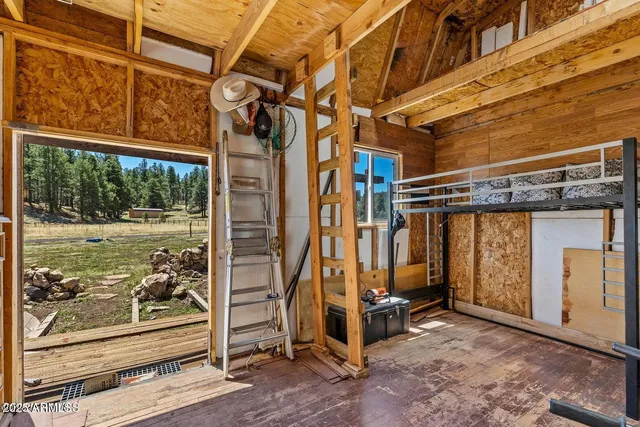 a view of a room with wooden floor