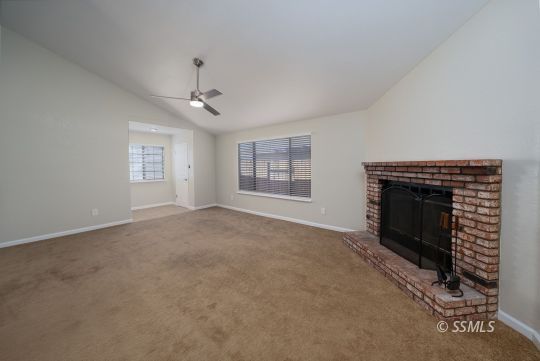 318 Reese Street Ridgecrest, CA 93555 - Photo 2 of 34 an empty room with windows and fireplace