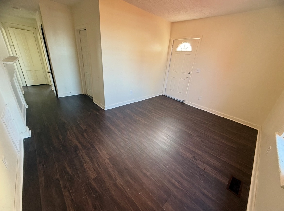26 Clarence Street, Unit 1 Bridgeport, CT 06608 - Photo 15 of 21 an empty room with wooden floor and mirror