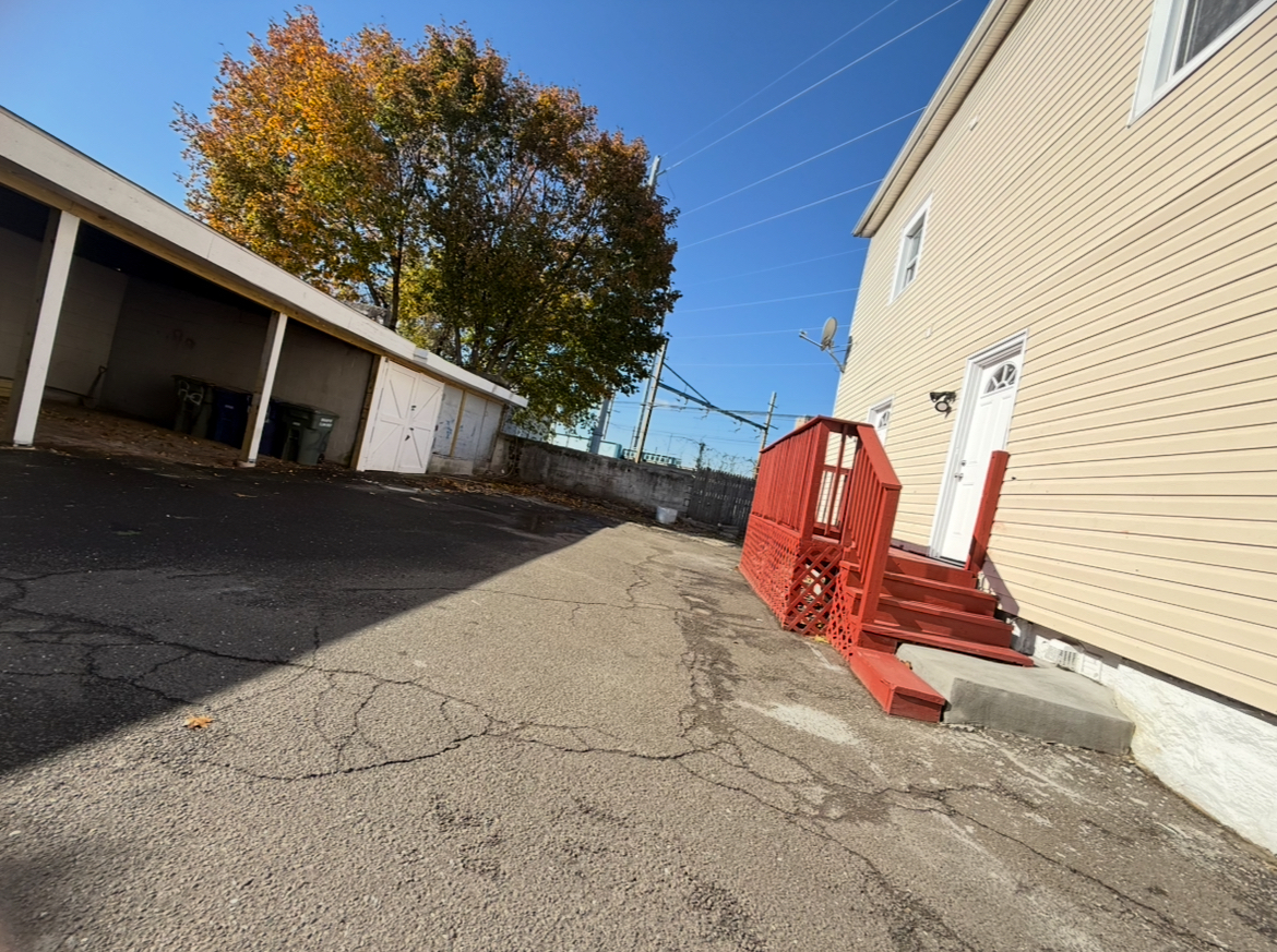 26 Clarence Street, Unit 1 Bridgeport, CT 06608 - Photo 18 of 21 a view of backyard with wooden fence and seating space