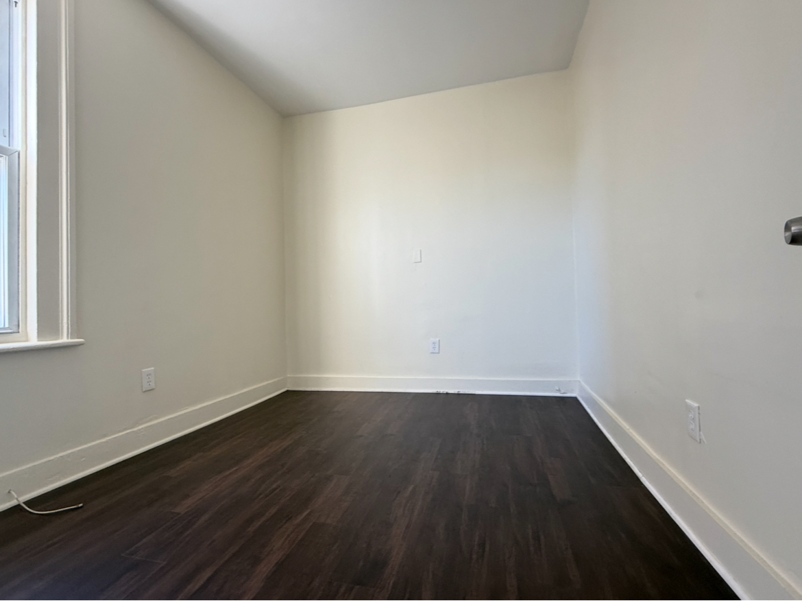 26 Clarence Street, Unit 1 Bridgeport, CT 06608 - Photo 6 of 21 a view of an empty room with wooden floor and a window