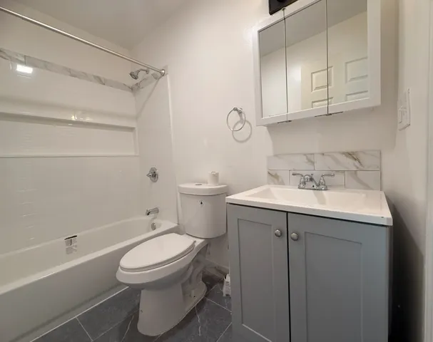 a bathroom with a sink a toilet and bathtub