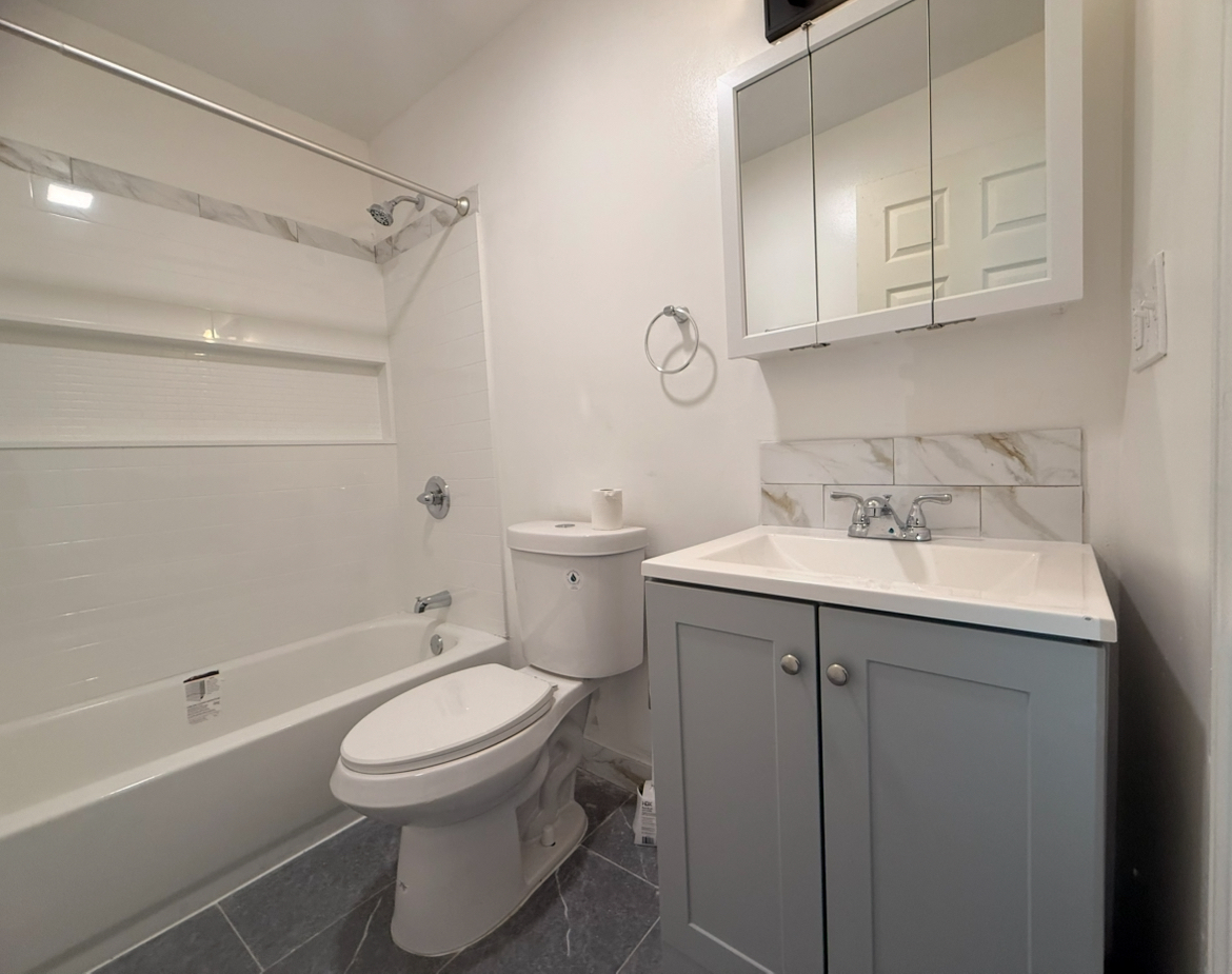 26 Clarence Street, Unit 1 Bridgeport, CT 06608 - Photo 9 of 21 a bathroom with a sink a toilet and bathtub