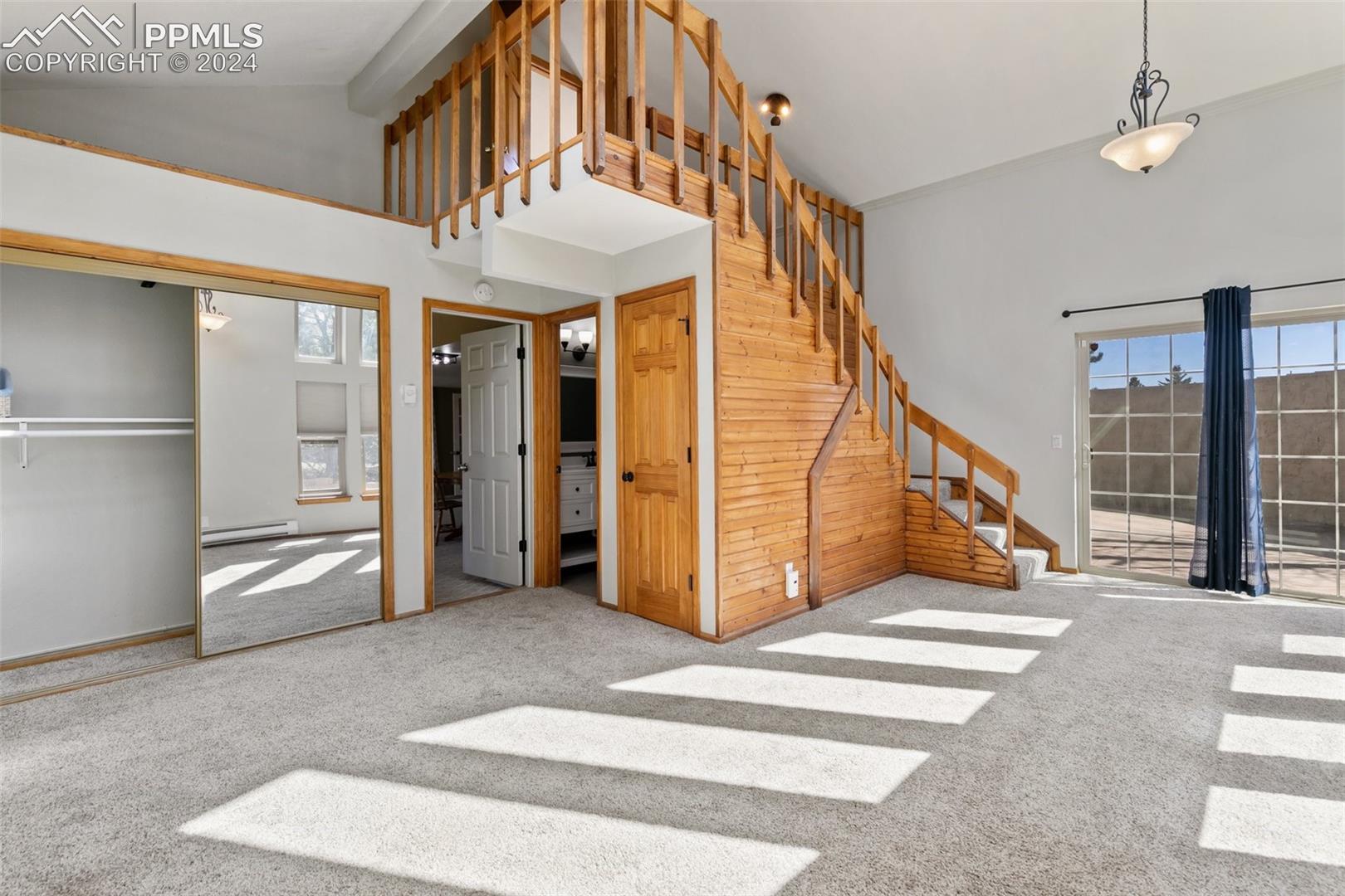 3830 Range View Road Monument, CO 80132 - Photo 34 of 50 Second part of the mother in law apartment/ suite. The stairs lead to a small loft and large additional room. The double French doors are the private entrance and lead out to the private patio,