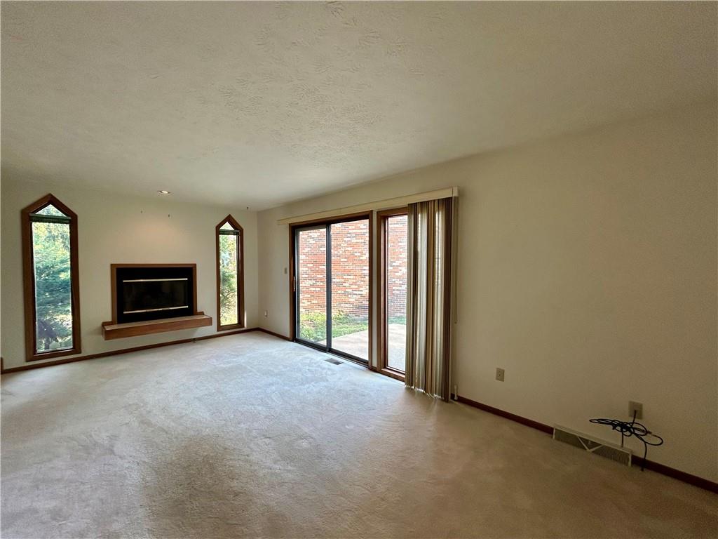 401 Spring Run Drive Monroeville, PA 15146 - Photo 14 of 31 an empty room with fireplace and windows