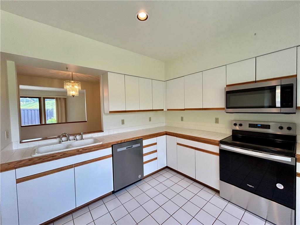 401 Spring Run Drive Monroeville, PA 15146 - Photo 6 of 31 a kitchen with stainless steel appliances granite countertop a sink and cabinets
