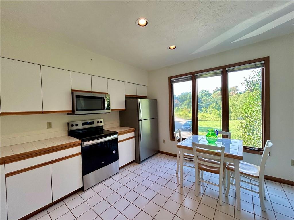 401 Spring Run Drive Monroeville, PA 15146 - Photo 8 of 31 a kitchen with stainless steel appliances a stove sink microwave and refrigerator