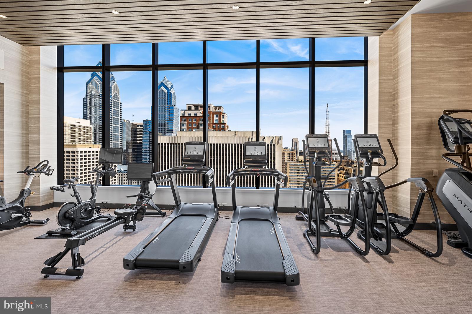 1911 Walnut Street, Unit 3003 Philadelphia, PA 19103 - Photo 19 of 27 a view of a gym equipment and floor to ceiling window