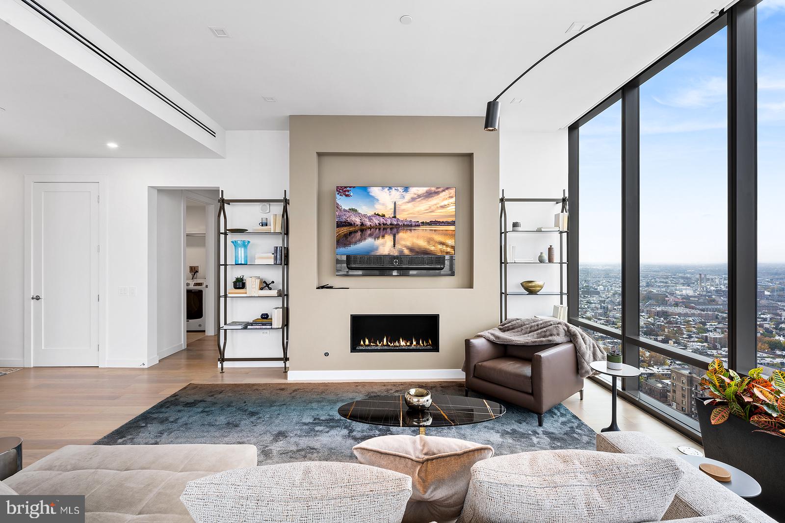 1911 Walnut Street, Unit 3003 Philadelphia, PA 19103 - Photo 10 of 27 a living room with furniture a fireplace and a floor to ceiling window
