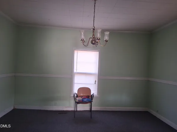 a room that has a window and a chandelier