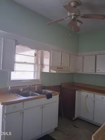a kitchen with a sink cabinets and window