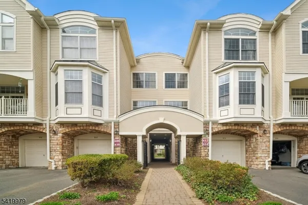 a front view of a residential apartment building with a yard