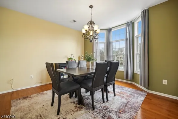 a view of a workspace with furniture and wooden floor
