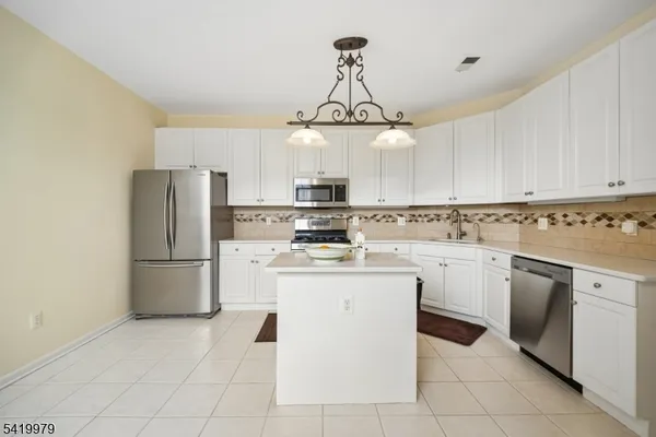 a spacious bedroom with a bed and a desk