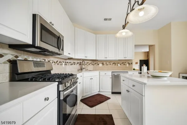 a spacious bathroom with a double vanity sink mirror and bathtub