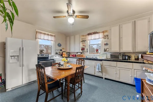 a kitchen with stainless steel appliances granite countertop a white cabinets and a refrigerator