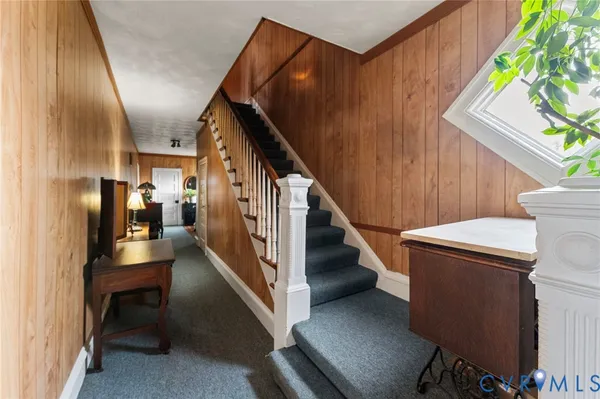 a view of entryway and hall with wooden floor