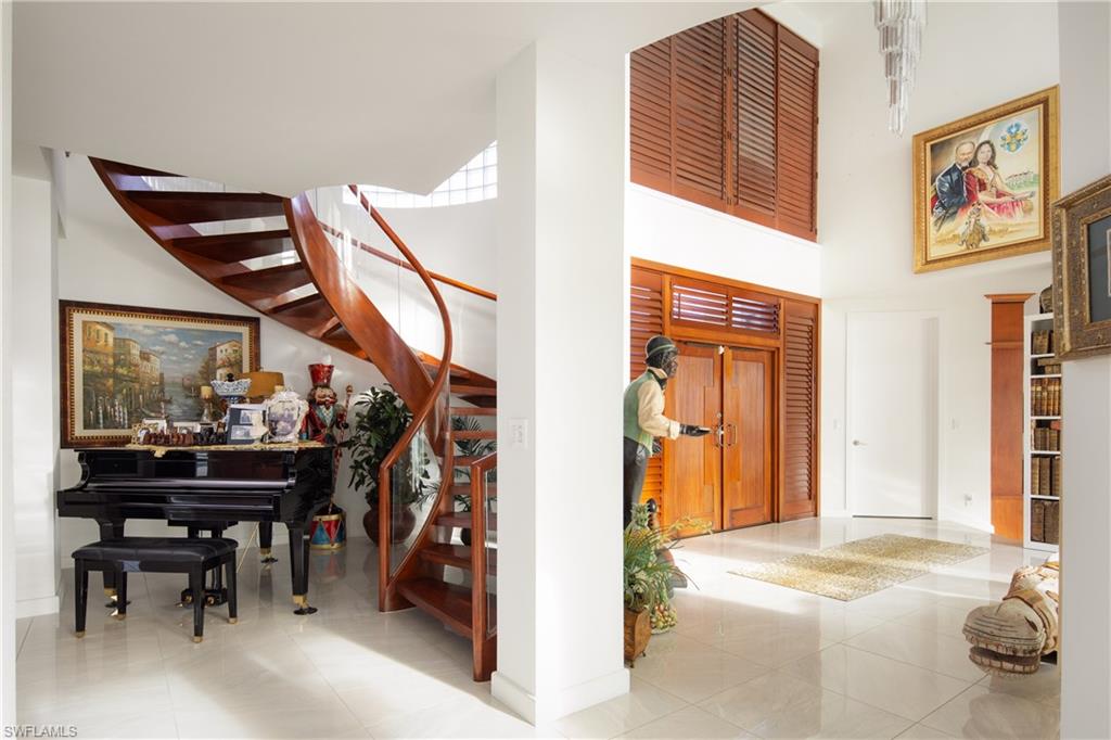 14040 Schultz Road Fort Myers, FL 33908 - Photo 23 of 48 Entrance foyer featuring stairway, tile patterned floors, and a towering ceiling