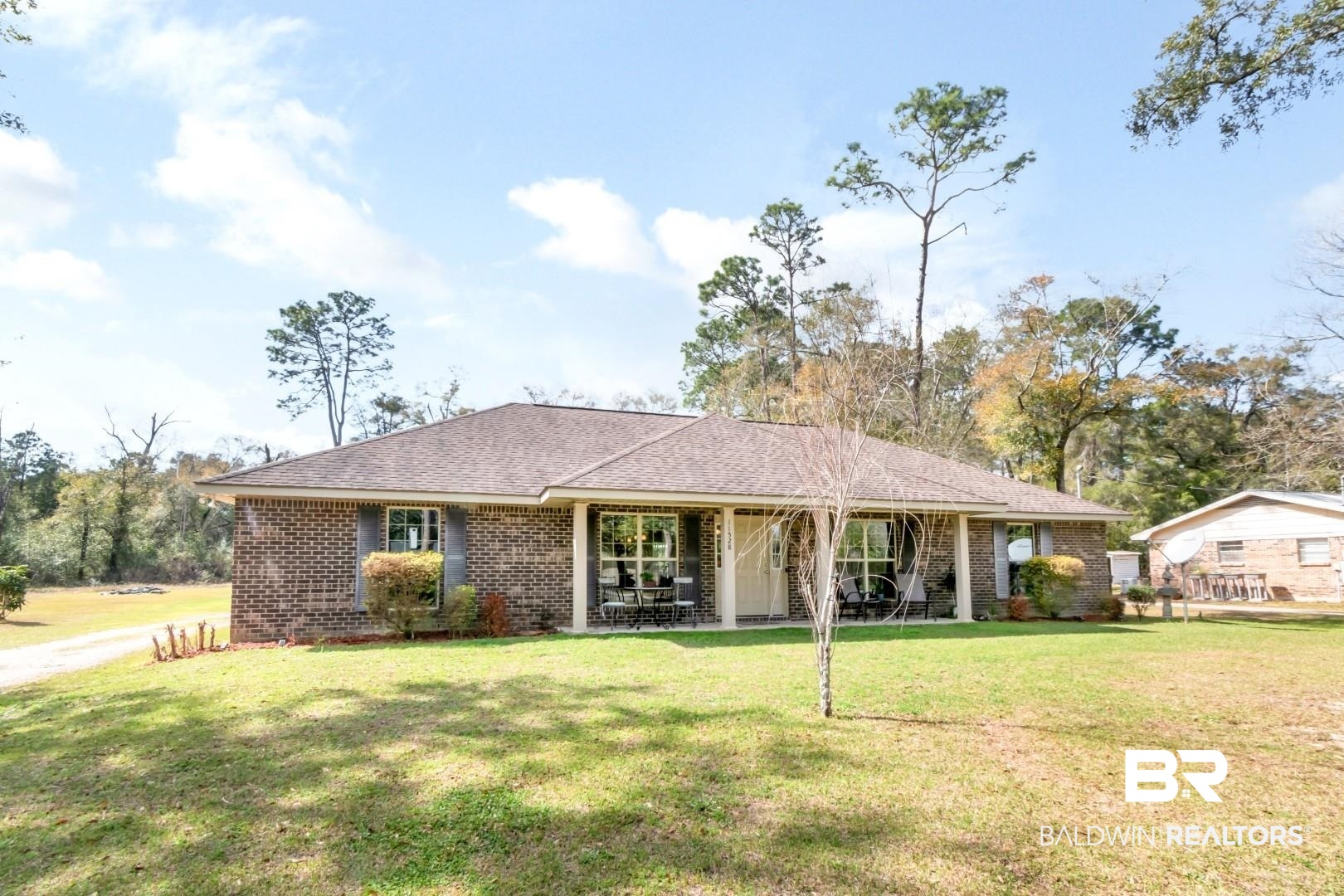 11528 Mocking Bird Lane Fairhope, AL 36532 - Photo 43 of 45 View of front of house with brick siding, a front yard, a patio area, and roof with shingles