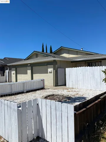 a view of a house with wooden fence