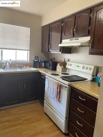 a view of a hallway with wooden floor and furniture